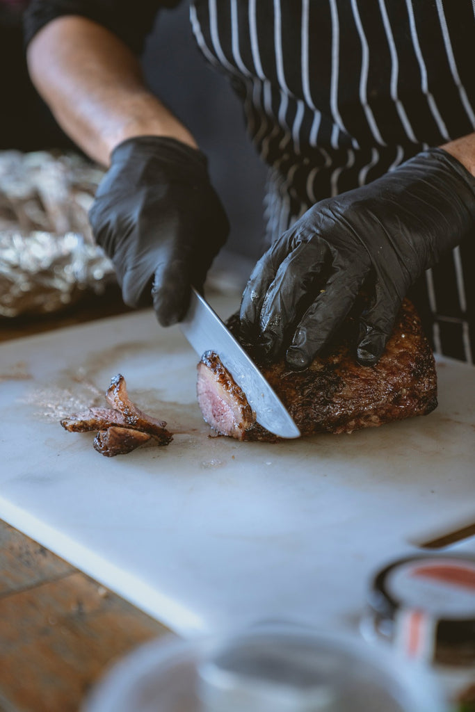 chef cutting a steak of kobe beef in a kitchen